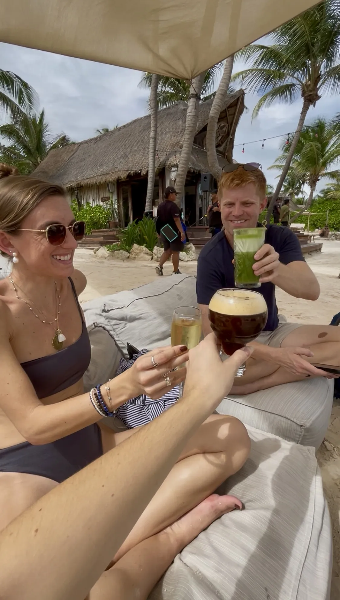 Lana enjoying drinks on the beach with friends